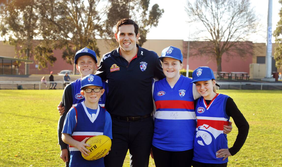 Brett Goodes with Harper Harradine, Jack Hoffmann, Ally Janetzki and Lily O'Loughlin at a Western Bulldogs Academy presentation at city oval in June. Picture: PAUL CARRACHER