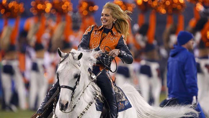Horseplay: Anne Justice Wegener rides the Denver Broncos mascot, Thunder, onto the field before the start of the Super Bowl. Photo: Reuters