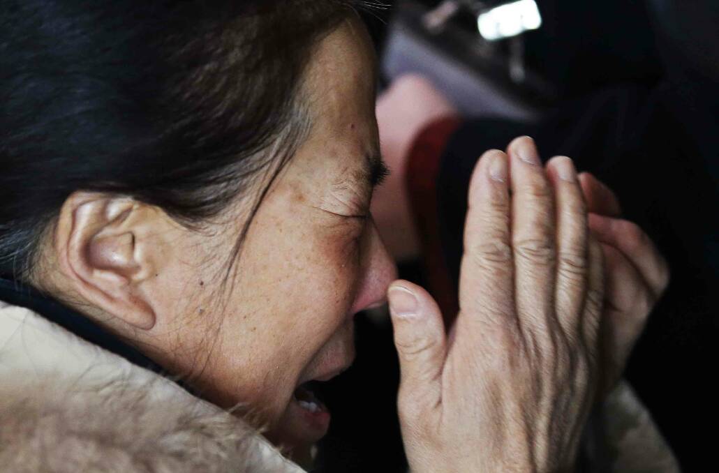 REFILE CLARIFYING CAPTION

A relative of a passenger onboard Malaysia Airlines flight MH370 cries at the Beijing Capital International Airport in Beijing March 8, 2014. The Malaysia Airlines flight carrying 227 passengers and 12 crew lost contact with air traffic controllers early on Saturday en route from Kuala Lumpur to Beijing, the airline said in a statement. Flight MH 370, operating a Boeing B777-200 aircraft departed Kuala Lumpur at 12.21 a.m. (1621 GMT Friday) and had been expected to land in the Chinese capital at 6.30 a.m. (2230 GMT) the same day. REUTERS/Kim Kyung-Hoon (CHINA - Tags: TRANSPORT DISASTER) Photo: KIM KYUNG-HOON