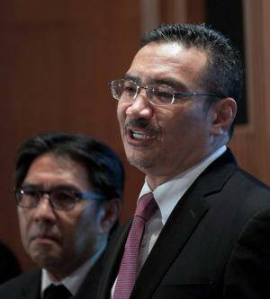 Malaysia's Minister of Defence and Acting Transport Minister, Hishammuddin Hussein (R) answers questions from journalists during a press conference at a hotel near Kuala Lumpur International Airport (KLIA) in Sepang on March 13, 2014. Malaysia on March 13 denied a media report that its missing airliner flew on for hours after last making contact, and said Chinese photos that raised hopes of a search breakthrough actually showed no wreckage. AFP PHOTO / MOHD RASFAN