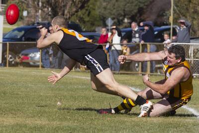 Clayton Holcombe slips a vigorous tackle from Mick Driscoll