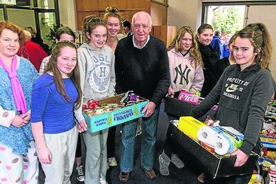 Members of Marian College s Minnie Vinnies, Lucinda, Amy, Jade, Jordan, Catherine, Evie, Sam, Tayla and Claire load up St Vincent De Paul s Derek Lister with donations.
