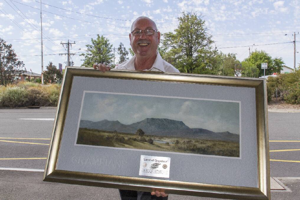 Artist Grant Thomas with the 'Land of Grandeur'.