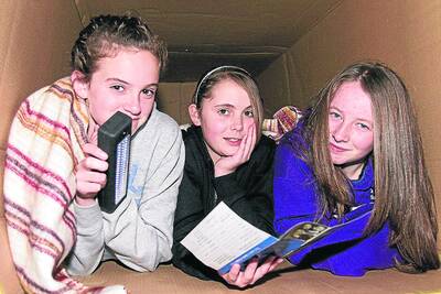 Jordan, Tayla and Amy swapped their bed for a cardboard box. Pictures: PETER PICKERING