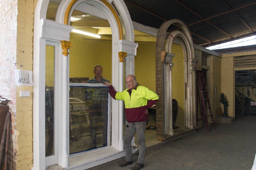 Laurie Brewster and Fred Ellis are pictured restoring the old bank windows at the Langi Morgala Museum. 
 Picture: PETER PICKERING