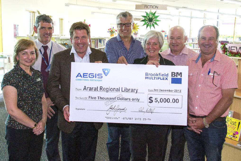 Regional Director Catherine Darbyshire, Hopkins Correctional Centre manager Pat McCormick, John Goudie AEGIS, Geoff Kellock Brookfield Multiplex, Ararat library team leader Evelyn Curley, Bill Jones from the Community Advisory Group and Mayor Paul Hooper at the cheque presentation.