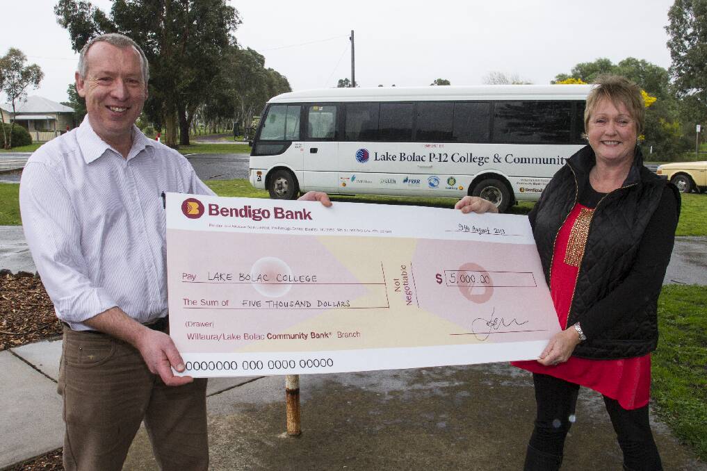 Bendigo Bank representative Trevor Link with Karen McIntyre and the cheque for the newly commissioned Lake Bolac Community Bus.