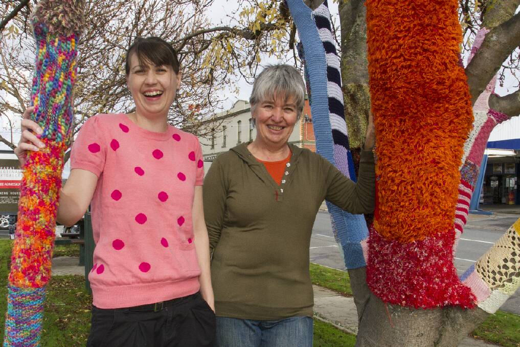 Jade Kahle and Sue Kennedy with some of the yarn bombed trees at the Ararat Regional Art Gallery. Picture: PETER PICKERING