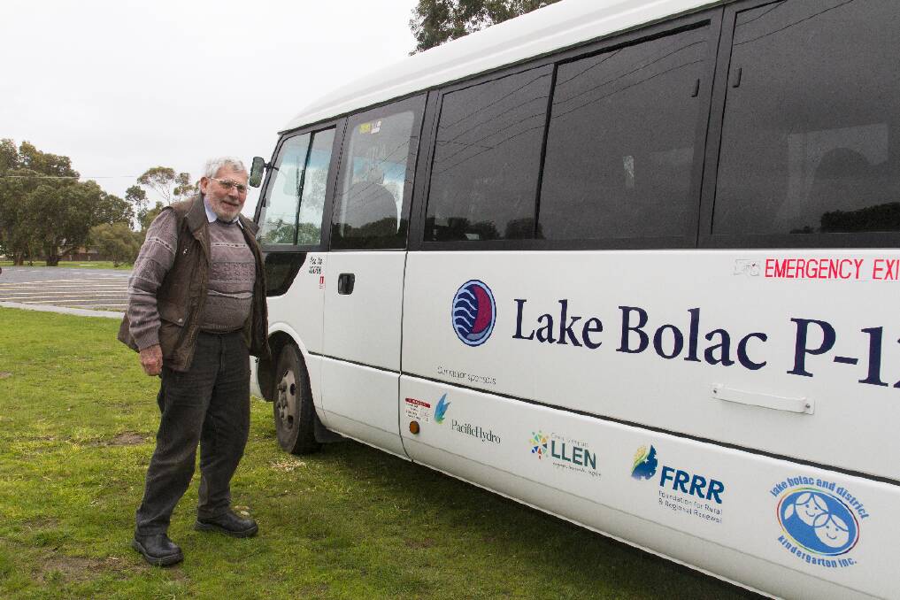 Lions Club president Tom Atkinson inspects the new bus.