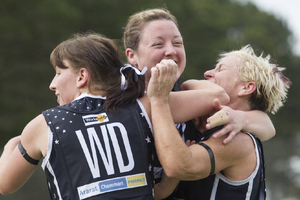 Caroline Rafferty, Sarah Leggett and Kelli Felini (right) celebrate the Ararat Eagles grand final netball win. The win had added significance with Felini returning to court after undergoing treatment for Breast Cancer.