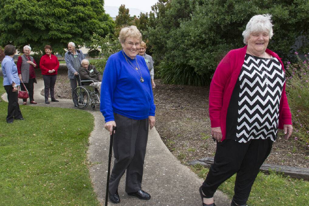 Norma Coffey and Helen Watson lead the walkers around the garden path. Picture: PETER PICKERING