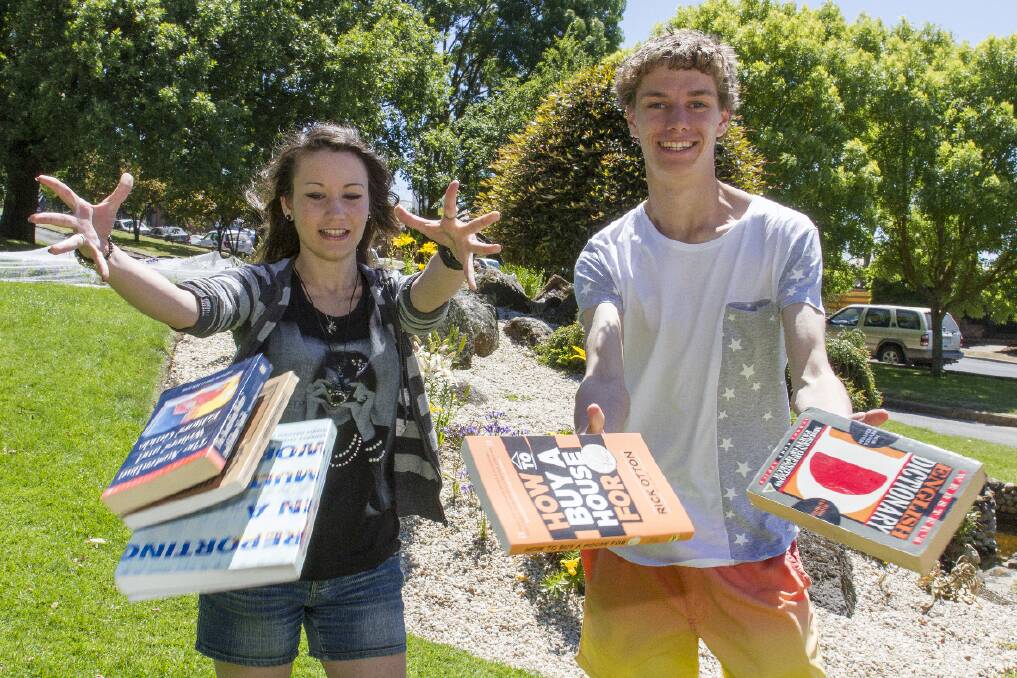 Marian College dux Maddalena Linton and Ararat College dux Nick Phillips throw the books away after learning of their results. Pictures: PETER PICKERING
