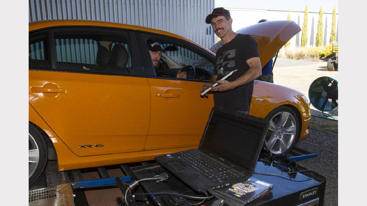 Andrew Wells and Mark Watson prepare a vehicle for the dyno.