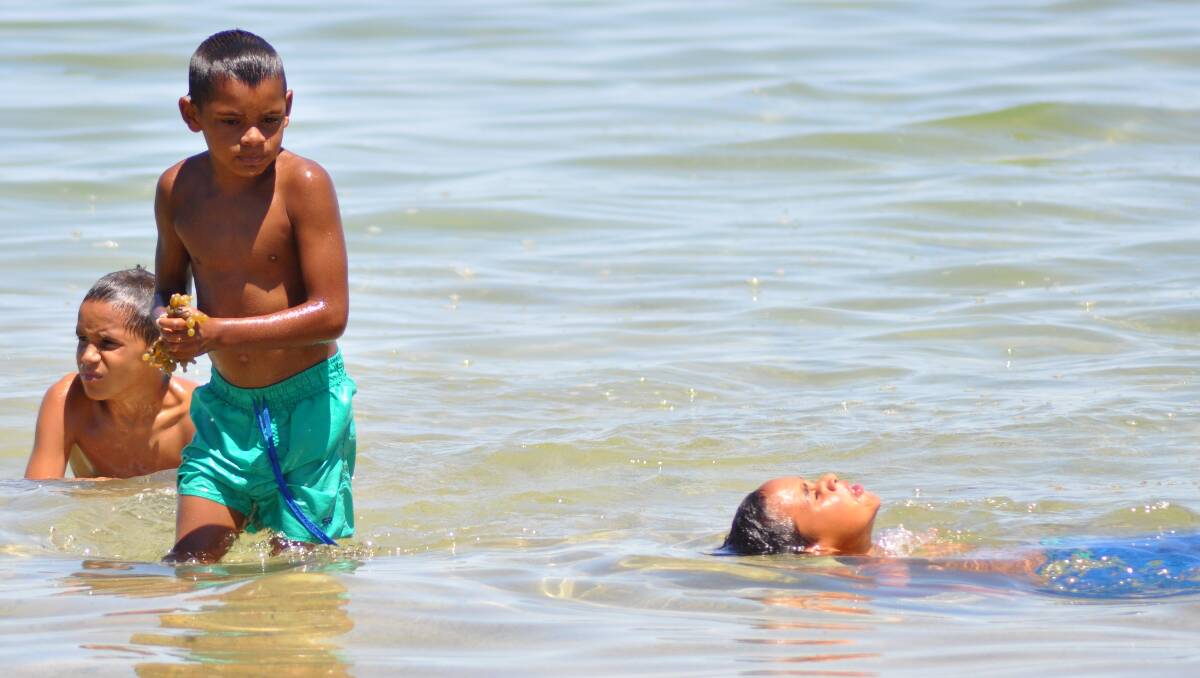 Brothers Jaziah, Jontae and Jairone Miller enjoy a swim at Murat Bay in Ceduna, South Australia.