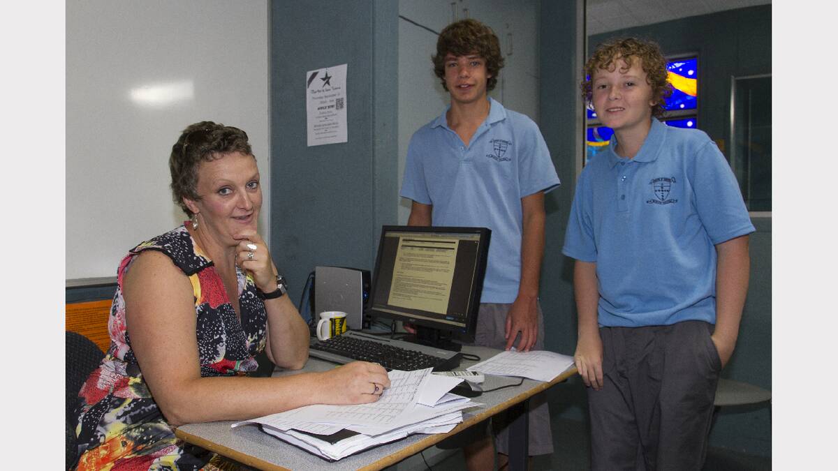 Teacher Tess Tonks ensures Riley and Austin have the right information at Marian College.