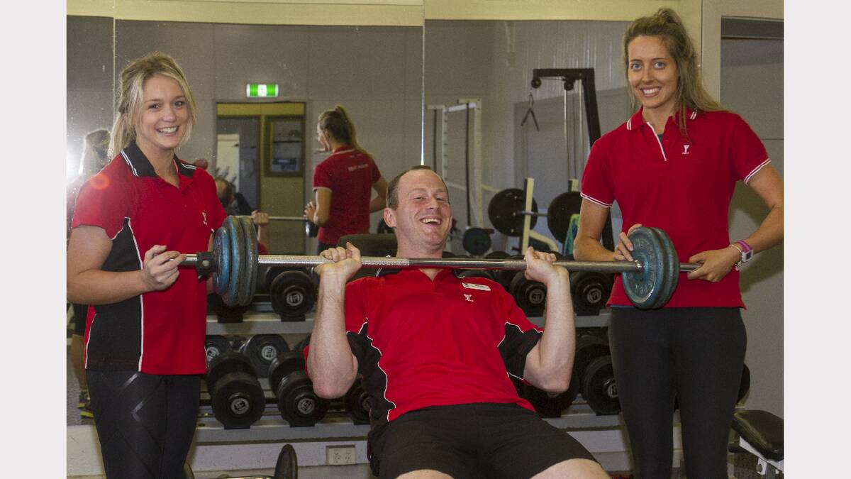 Lauren Armstrong and Mikaela Graham assist Ararat YMCA Health and Fitness coordinator Peter Harrison in the weights room. Picture: PETER PICKERING