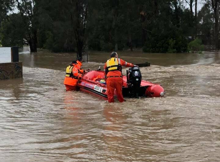 FLOODWATER: The boat crew navigating its way through the flooded streets of Traralgon. Picture: CONTRIBUTED
