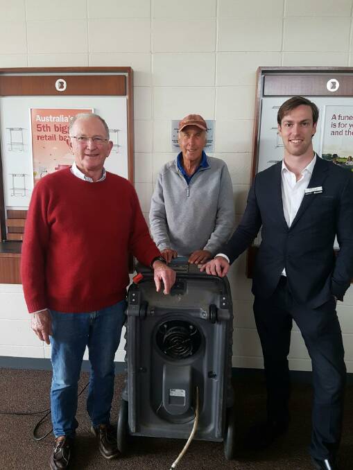 Community Bank Board chairman Rowley Paterson, board member Colin McKenzie and Willaura & Lake Bolac Community Bank Branch Manager Jack Oswald with one of the dehumidifiers. Picture: SUPPLIED