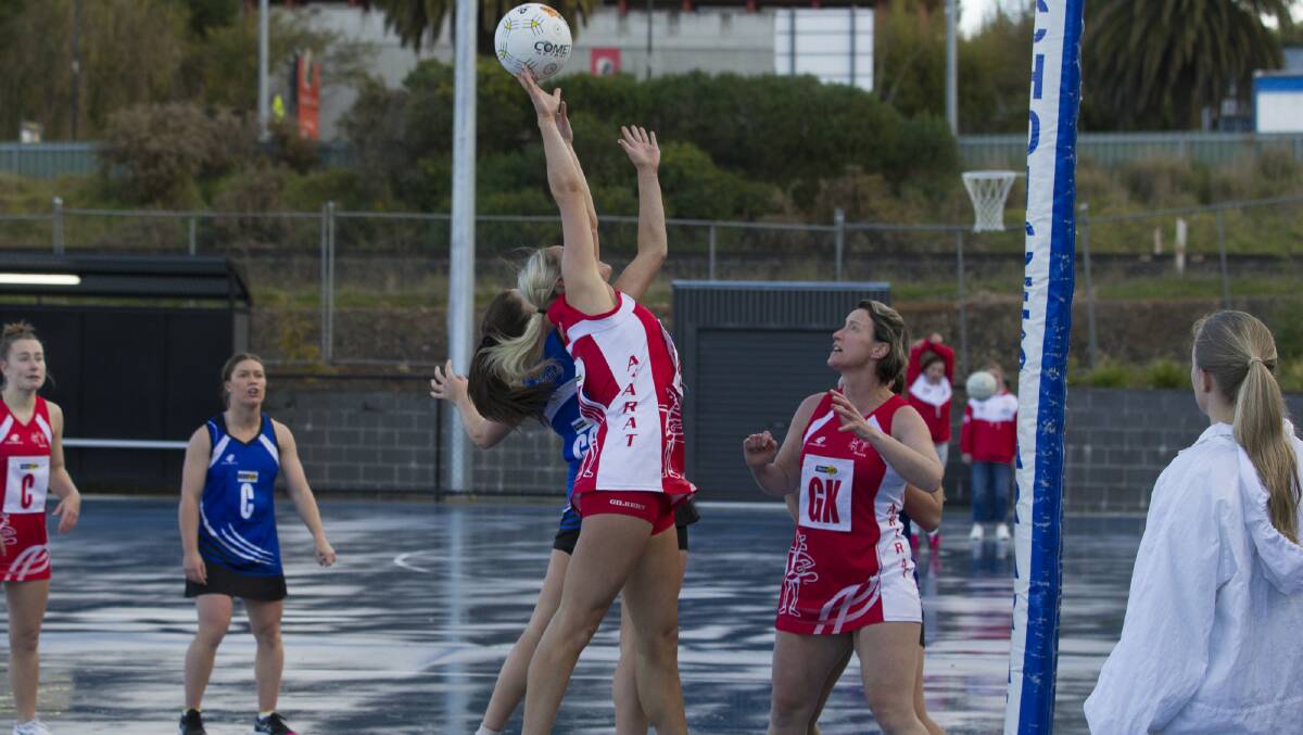 FINGER TIPS: Racquel Scott reaches high to stop an opposition attack. Picture: PETER PICKERING