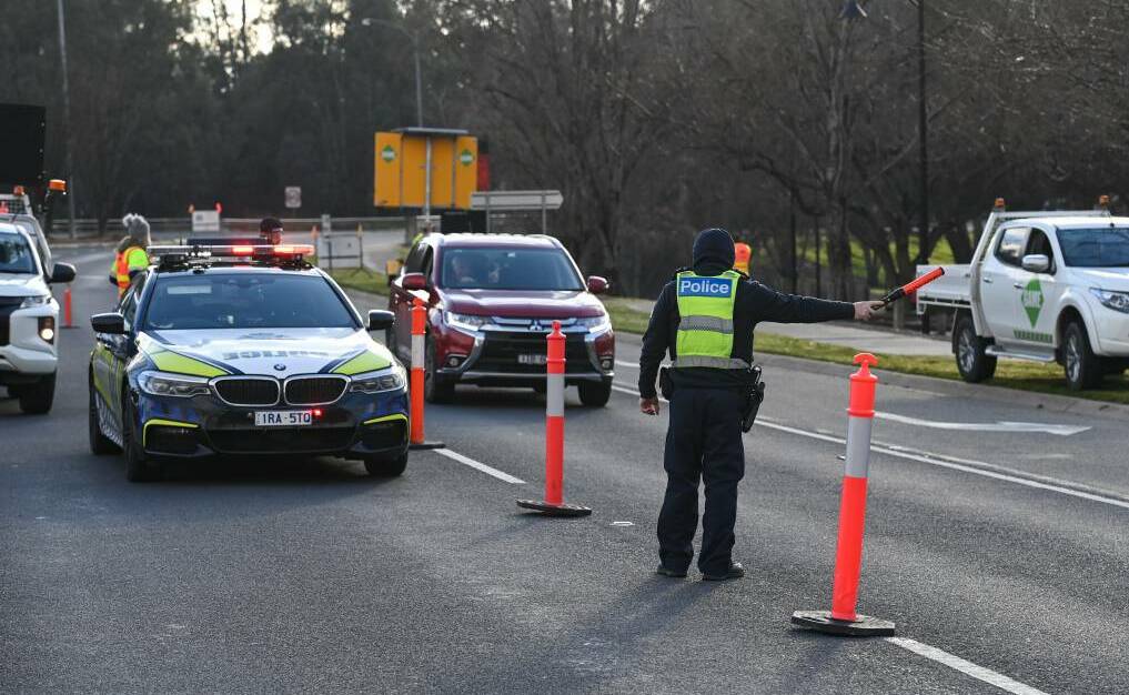 Victoria Police man a checkpoint to conduct ID and permit checks along the Lincoln Causeway in Wodonga. Picture: Mark Jesser