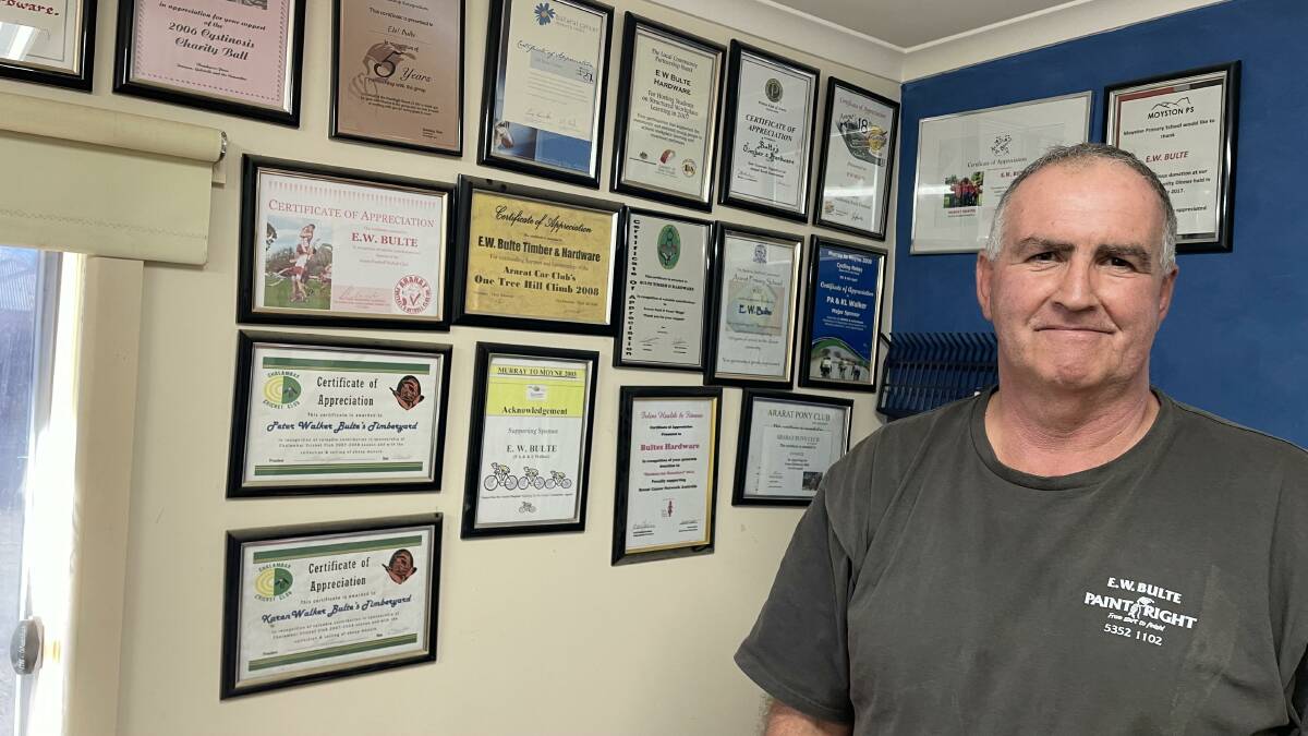 Peter Walker with the wall of certificates from some of the community organisations he has supported over the years. Picture by Sheryl Lowe