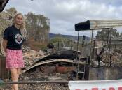 Wild MIsty Mountain owner Jemma Purcell by the historic train carriage from the 1800s which burned in the February 2024 fires. Picture Sheryl Lowe. 