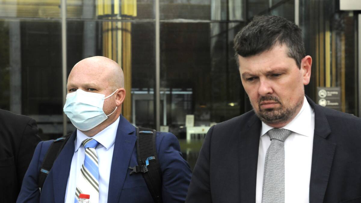 Mark Wallis, left, leaves court with his solicitor, Michael Kukulies-Smith, on Thursday. Picture: Blake Foden