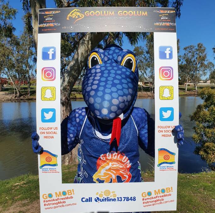 Wutchie the goanna tests out a selfie frame at the Wimmera River in Horsham.