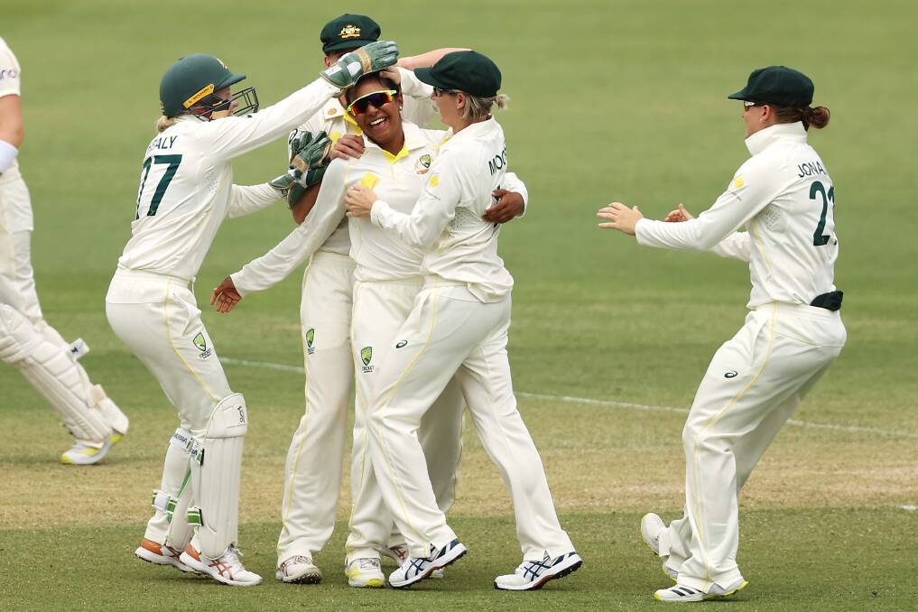 Debutant Alana King is mobbed by teammates after claiming her first Test wicket. Picture: Getty