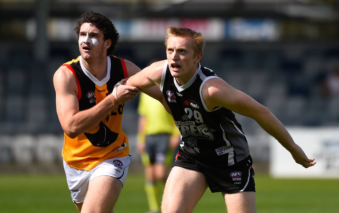 Bailey Schmidt of Dandenong and Patrick Glanford of the Rebels compete in a ruck contest. (Picture:Adam Trafford)
