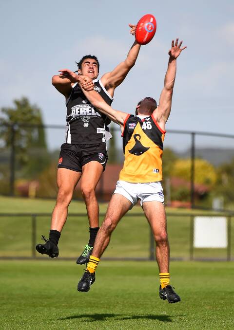 Jayden Wright of the Rebels and Darius Popa of Dandenong in action. (Picture: Adam Trafford)