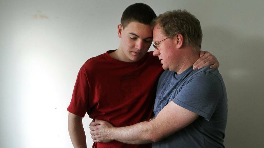 Ben Oakley is supported by his father Michael in this May, 2015 photo. He credits cannabis oil with easing his suffering and allowing him to live more independently. Picture: Sylvia Liber