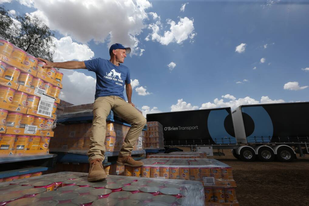 ACTION STATIONS: Paul Matuschka helps load pallets of dog food donated by Mars Petcare onto trucks that will join the 2019 Burrumbuttock Hay Runners convoy to Quilpie in Queensland. Picture: KYLIE ESLER 