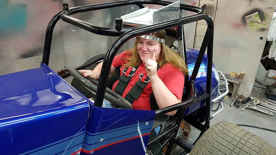 Barbralea Smith inside a vintage speedcar restoration project. The Lithgow woman describes herself as the resident 'mud monkey' of the pit crew.