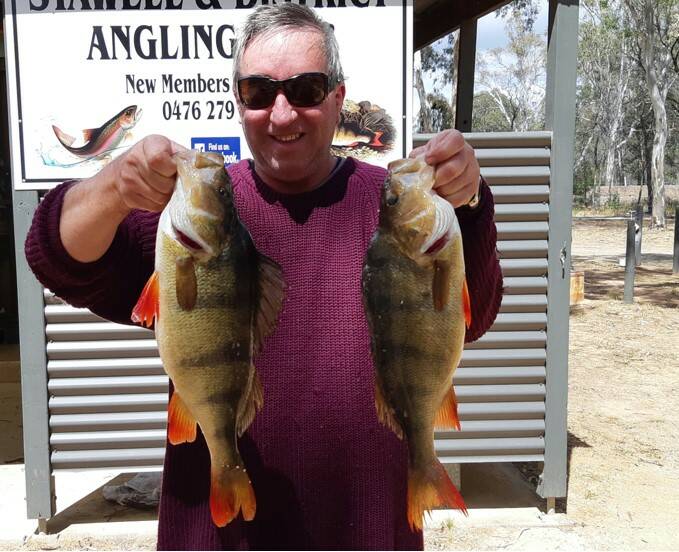 HAPPY ANGLER: Paul Whelan with two of his reddies. Picture: SUPPLIED