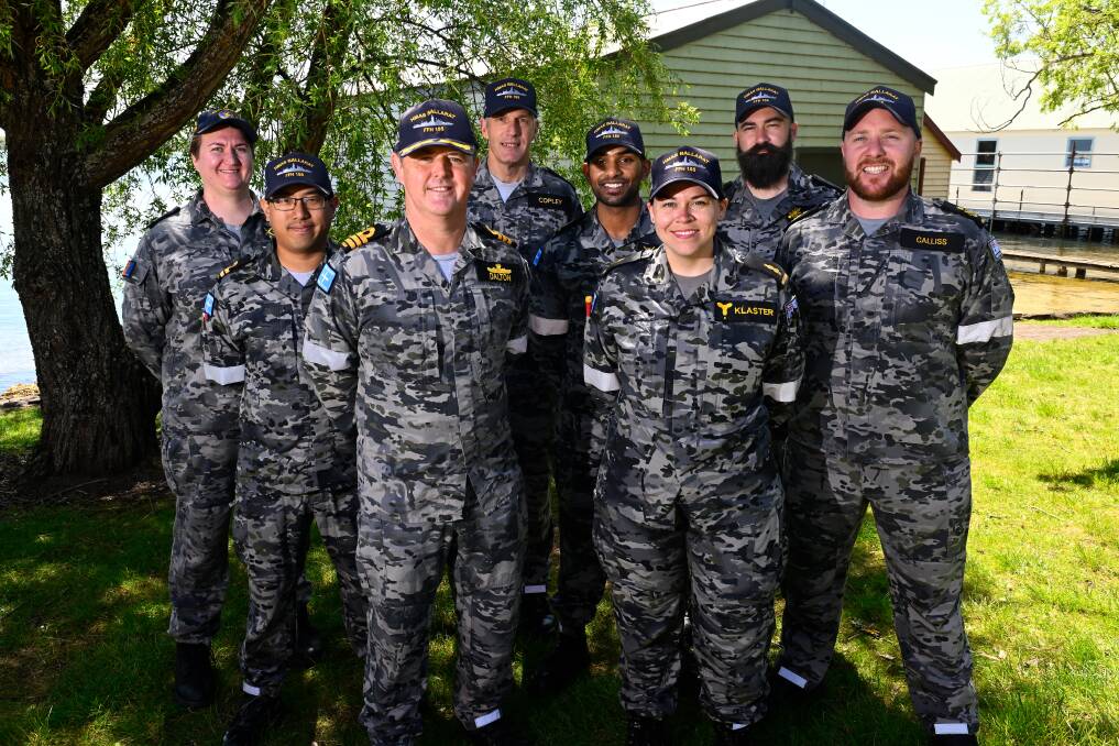 HMAS Ballarat Commanding Officer Ben Dalton with members of the crew at Lake Wendouree. Picture by Adam Trafford