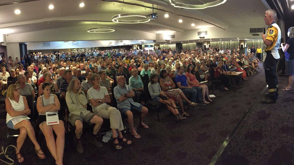 RFS incident controller Superintendent Mark Williams addresses a packed community meeting at the Bomaderry Bowling Club. Photo: Stuart Thomson