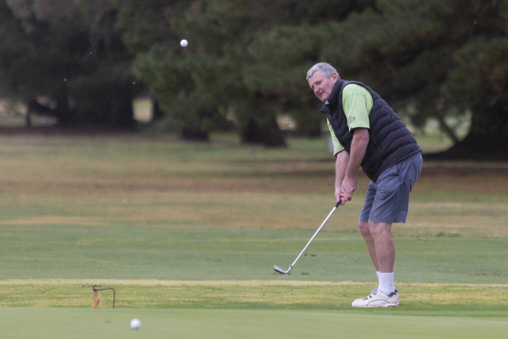 WET AND WINDY: While the Chalambar Golf Club championships round was postponed, Steve O'Connell took the chance to practice on Saturday. Picture: Peter Pickering