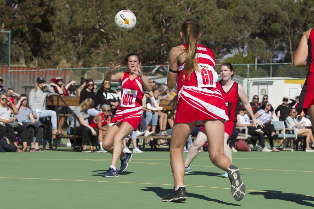 TEAMWORK: Monique Scott takes a pass from Raquel Scott during the Good Friday match. Picture: Peter Pickering