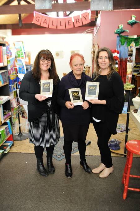 PACKED LINEUP: Wimmera Eisteddfod's Tanya Hahne and Venetia Elbourne-Hobbs with Redrock Books and Gallery's Gill Venn, centre. The gallery is selling the programs for this year's event. Picture: ALEXANDER DARLING