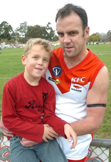 Paddy Turner, then 6, with dad Scott Turner during his playing days with the Ararat Rats. File picture