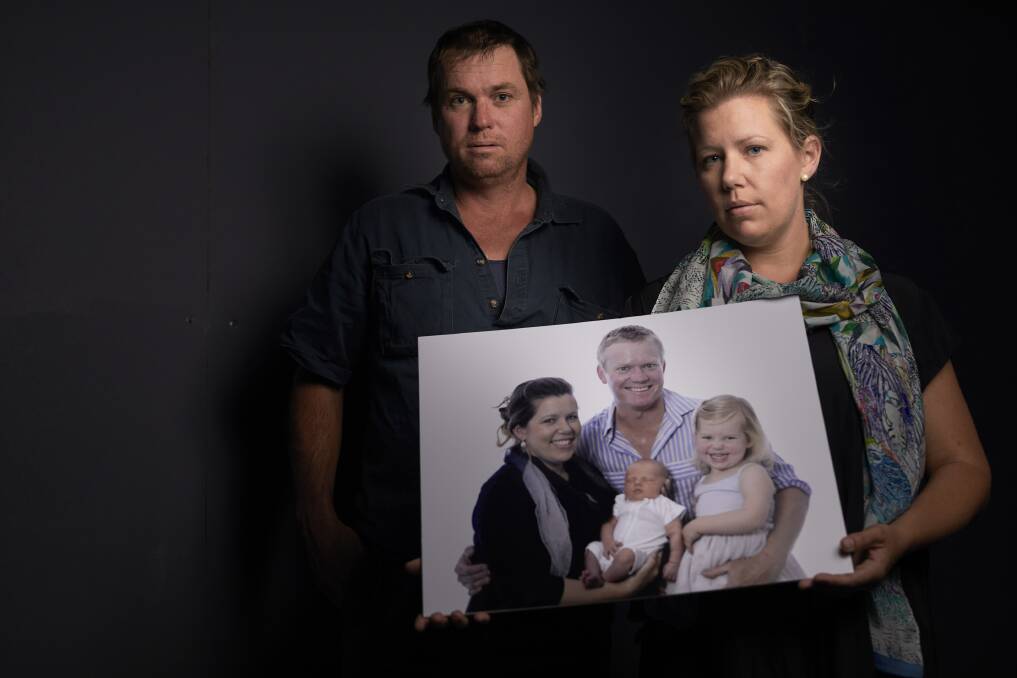 A father lost: Charlie Howkins' brother Reg and wife Lana Cormie with a family photo.  Charlie was one of two workers killed when a trench collapsed on a construction site just outside of Delacombe on March 21. Picture: Luka Kauzlaric 