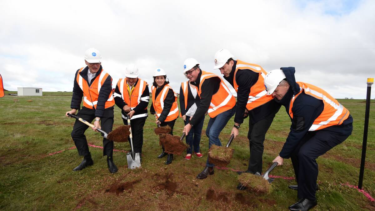 Premier Daniel Andrews (centre) is joined by a small army to help turn the first sod at Stockyard Hill on Thursday. Picture: Lachlan Bence 