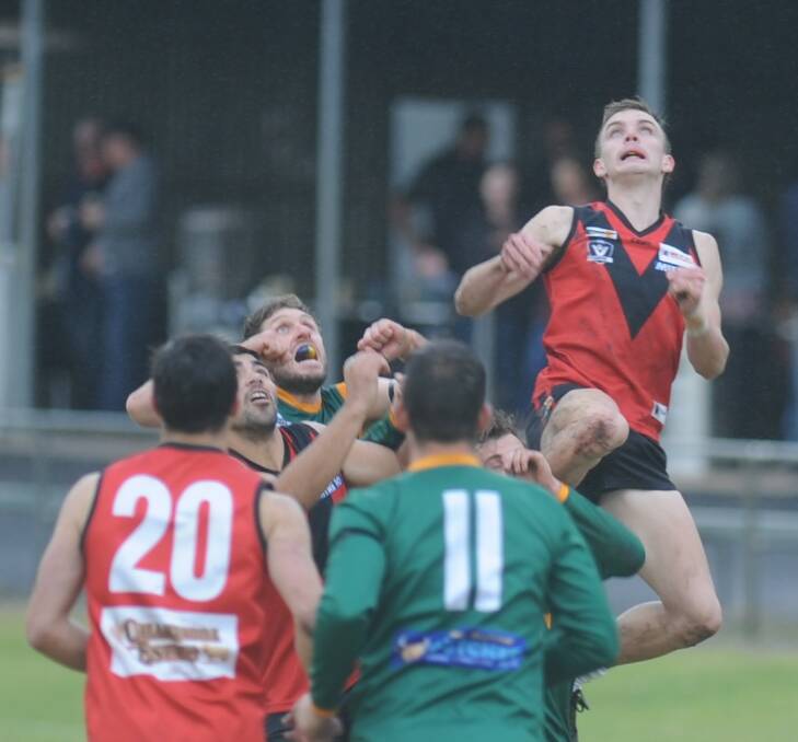 BOOST: Stawell's Sam Chatfield uses his opponent as a stepladder in his attempt to take a mark. Picture: MATTHEW CURRILL