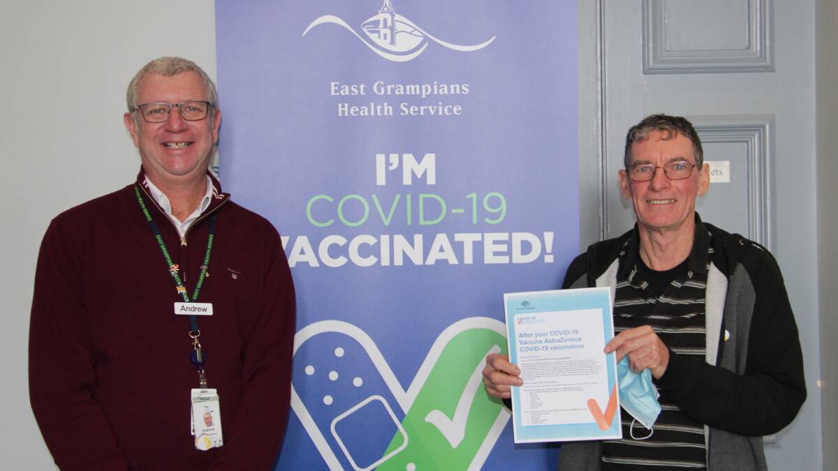 MILESTONE: EGHS chief executive Andrew Freeman congratulating the 1000th recipient of the COVID-19 vaccination at the EGHS Vaccination Clinic, Jim Stringer. Picture: CONTRIBUTED