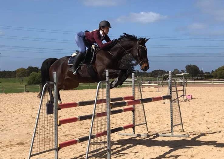 READY: Ararat Marion College student Hannah Wigg
jumping with her horse Lilly. Picture: CONTRIBUTED: 