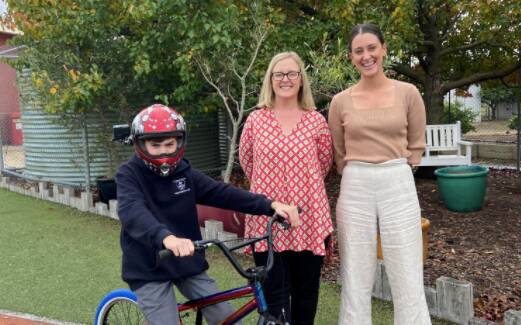 LEARNING: St Mary's Primary School teachers Eliza Griffiths and Georgie Peel have completed their Bike Ed training and are ready to help students like Jacob learn to cycle safely. Picture: CONTRIBTUED