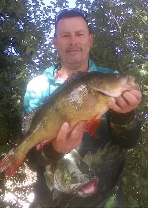 YOU BEAUTY: Angling club member Neal Dowsett shows off his 46cm redfin. 