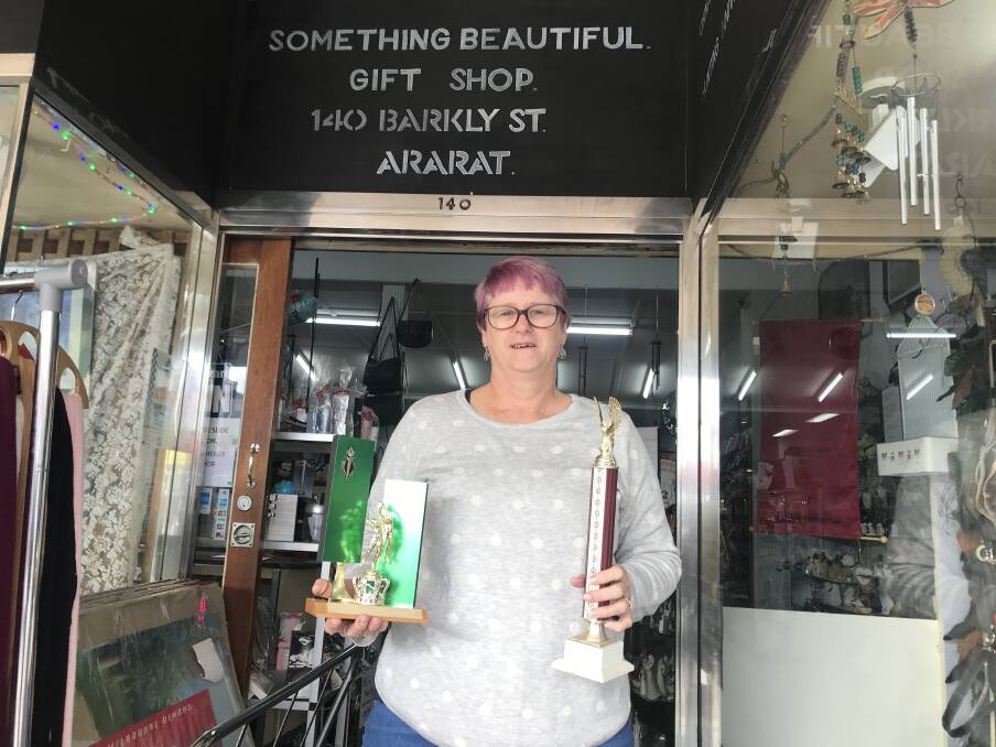Debbie O'Brien with some of the donated trophies junior clubs can enquire about at her shop. Picture: CASSANDRA LANGLEY