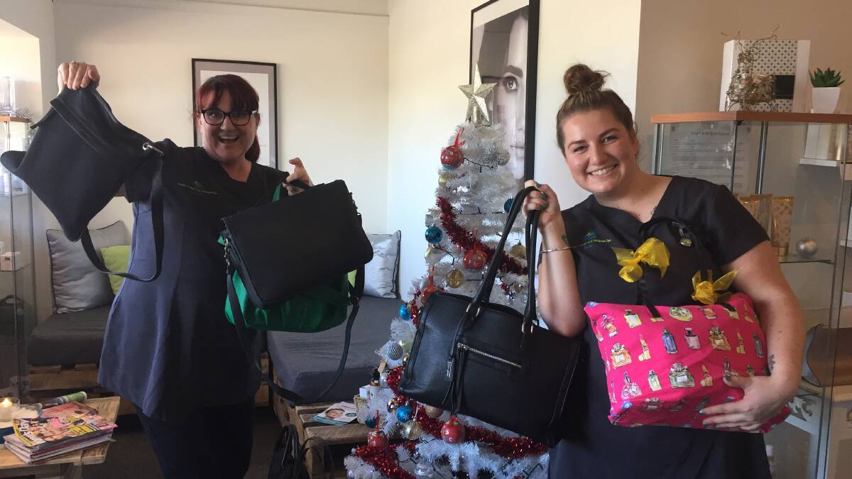 FOR A GOOD CAUSE: Kim Salmi and Bree Bowater with some of the bags that were donated to the ‘Share the Dignity – It’s in the bag’ campaign. Picture: CASSANDRA LANGLEY 
